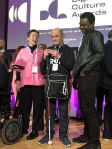 Photo from the ACE digital inclusion awards - three people standing on a stage