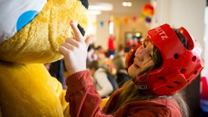 A young girl meets Pudsey the Bear