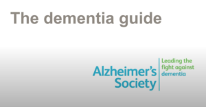Screenshot from video: Title board with text says: "The dementia guide", underneath is the Alzheimer's Society logo which says; "leading the fight against dementia"
