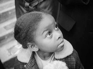A young girl no older than five years old looks up to her left. The photograph is in black and white. This is a still from the short film "Jemima and Jonny"