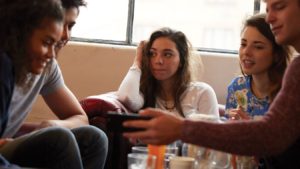 Group of young people sitting on sofa