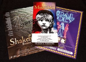 Photo of theatre brochures with captioned perfomance information on them, including Les Miserables