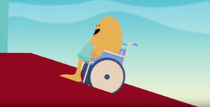 An animated bean-shaped yellow creature sits in a wheelchair and pushes it uphill. The ground is red and the background is blue.