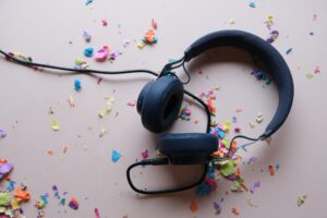 Headphones and rainbow coloured confetti