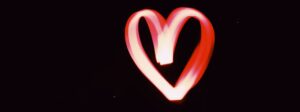A red and white heart made from light